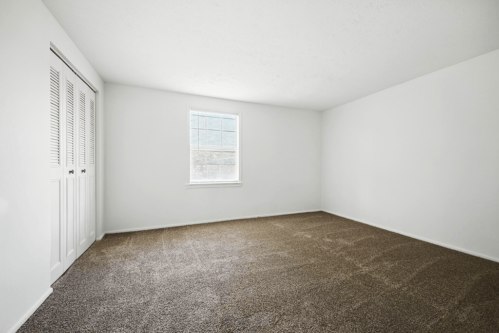 Bedroom in a 3-bedroom townhome at Ashton Pointe Apartments.