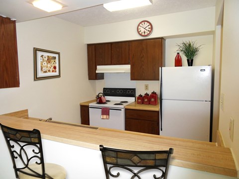 A kitchen with a refrigerator, stove, and oven.