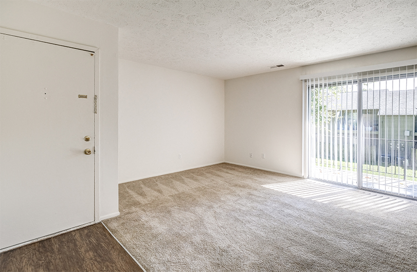 Apartment Living Room with a sliding door leading to a patio at The Woods of Eagle Creek