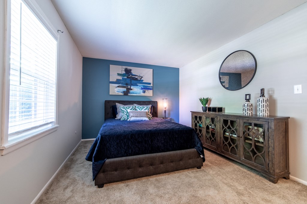 Spacious bedroom with a window at Ashton Brook Apartments