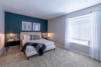 Bedroom with a Window at Woodbridge Apartments Bloomington - Photo Gallery 27