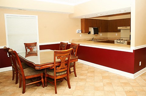 a dining room with a table and chairs in a kitchen