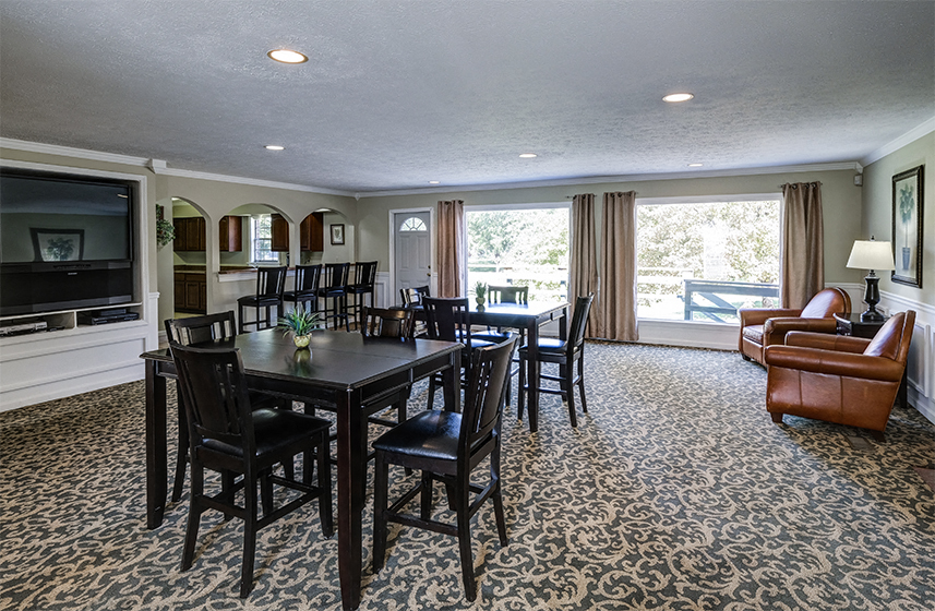 Clubhouse with seating and entertainment center at Ashton Pointe Apartments