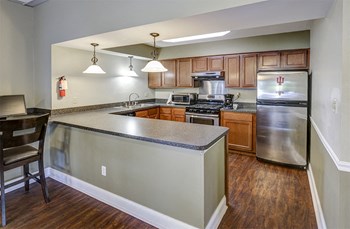 Clubhouse Kitchen at Woodbridge Apartments Bloomington - Photo Gallery 10