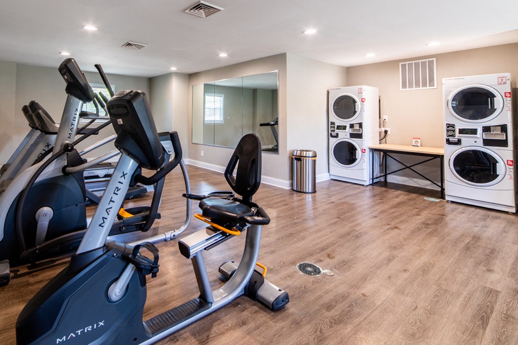 Fitness center at Ashton Brook Apartments features washers and dryers