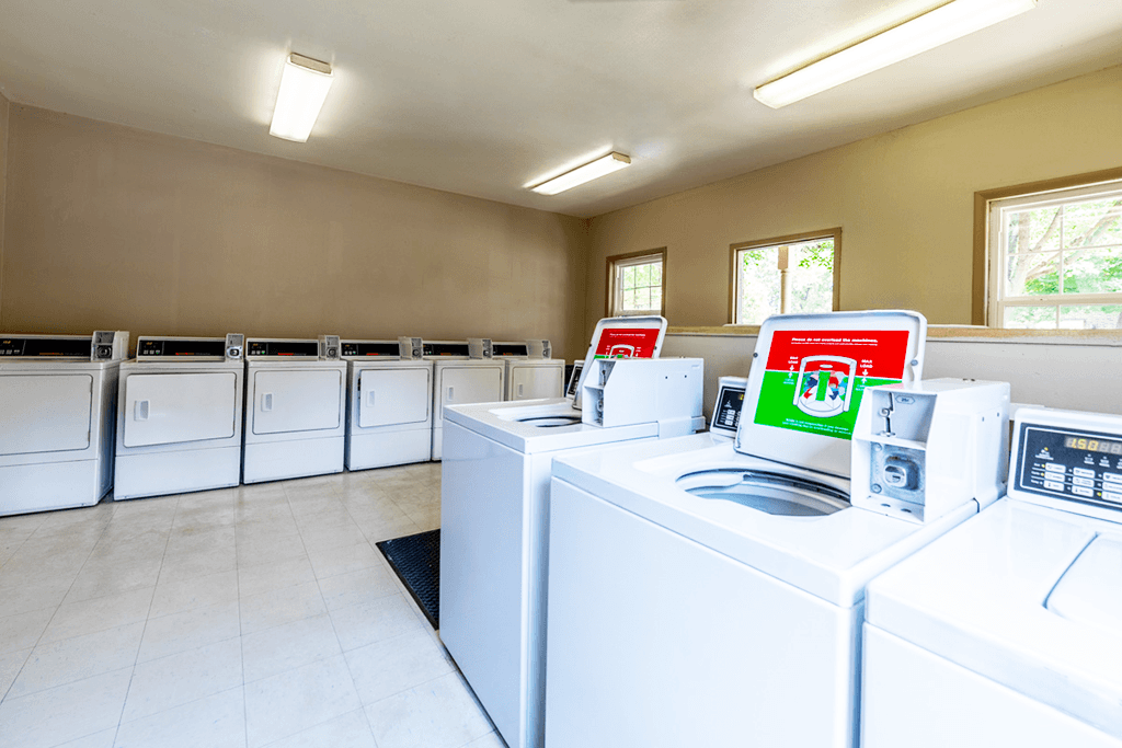 A laundromat with rows of washers and dryers.