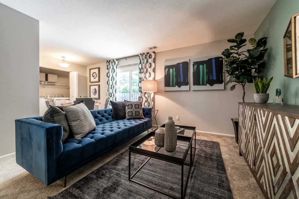 Ashton Brook Apartments offer an open living and dining area with access to a patio.