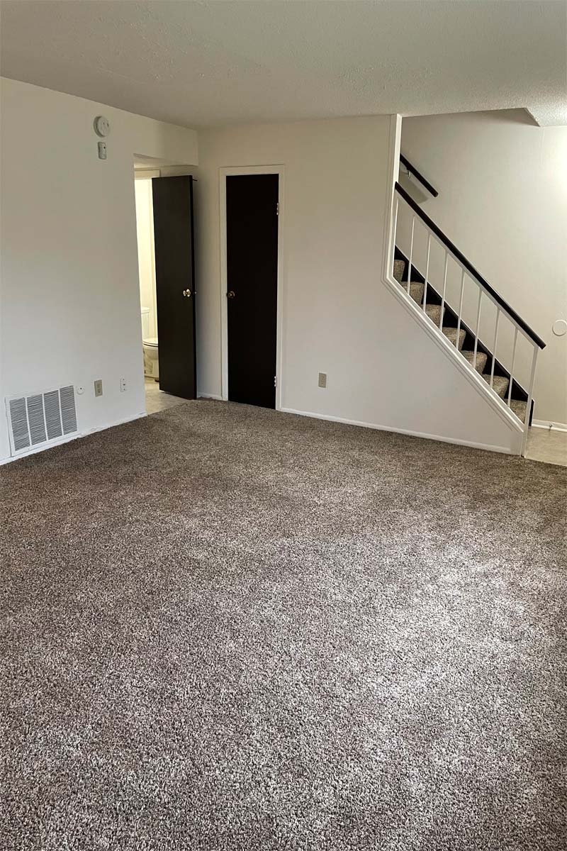 Living Room with Stair Access at Carriage House West.