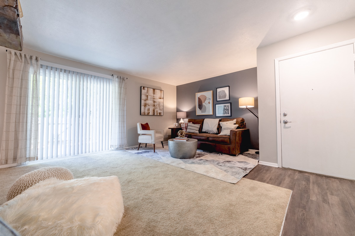 Living Room with Patio Access at Woodbridge Apartments Bloomington
