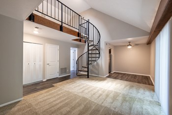 One-Bedroom Apartment Living Space with Loft Access at Woodbridge Apartments Bloomington - Photo Gallery 29