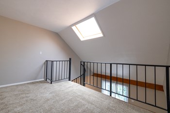 An Open Loft Space in the One Bedroom with Loft Apartment at Woodbridge Apartments Bloomington - Photo Gallery 30