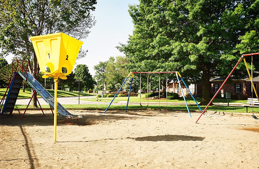 Playground with slides, swings, and basketball hoop at Briarwood Lafayette.