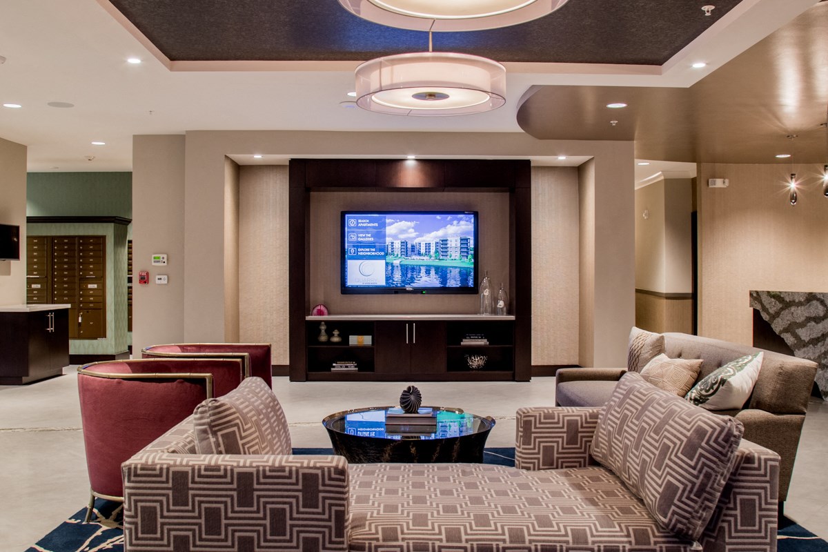 a living room with couches and chairs and a television