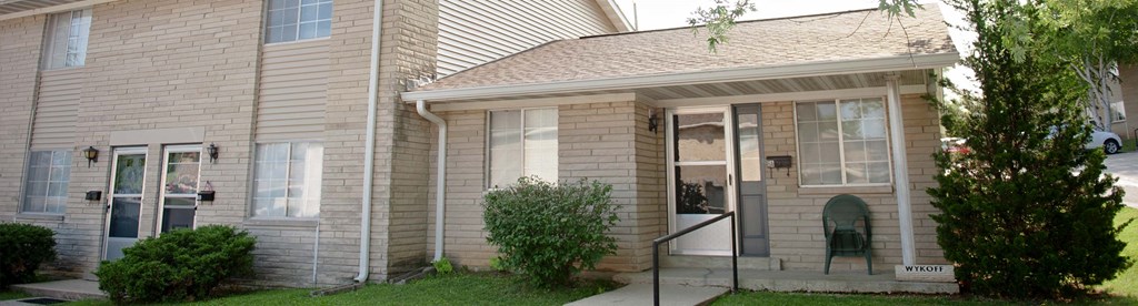a white house with a front porch and a glass door