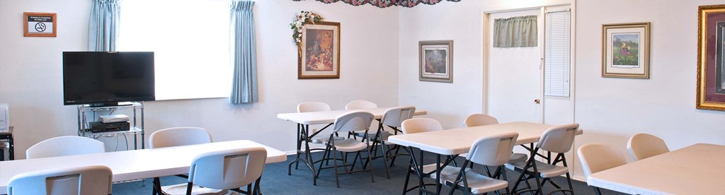 a dining room with tables and chairs and a television