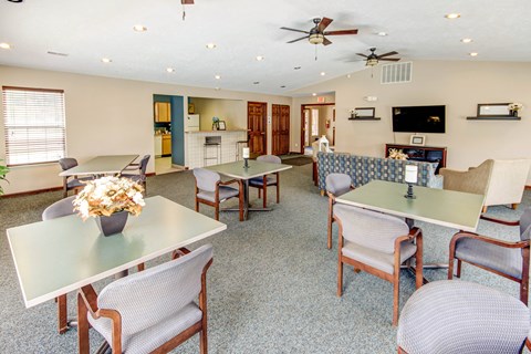 A living room with a dining table and chairs.