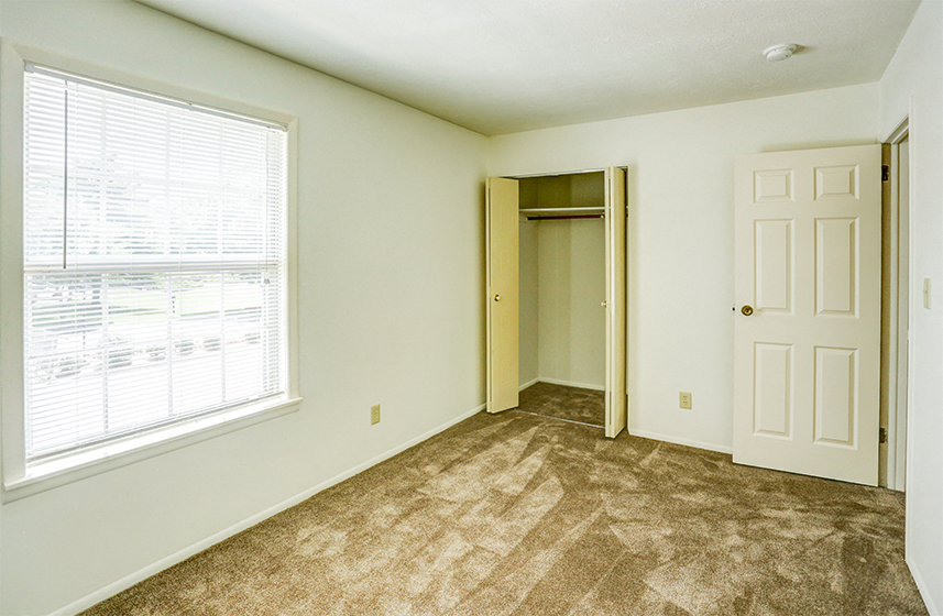 Townhome Guest Bedroom with a Window and a Closet at Williamsburg on the Lake Valparaiso
