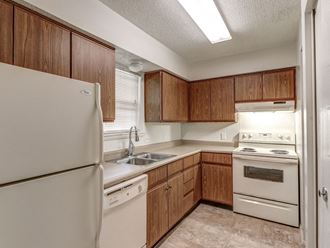 Townhome kitchen at Ashley Pointe Apartments with white appliances and lots of cabinets