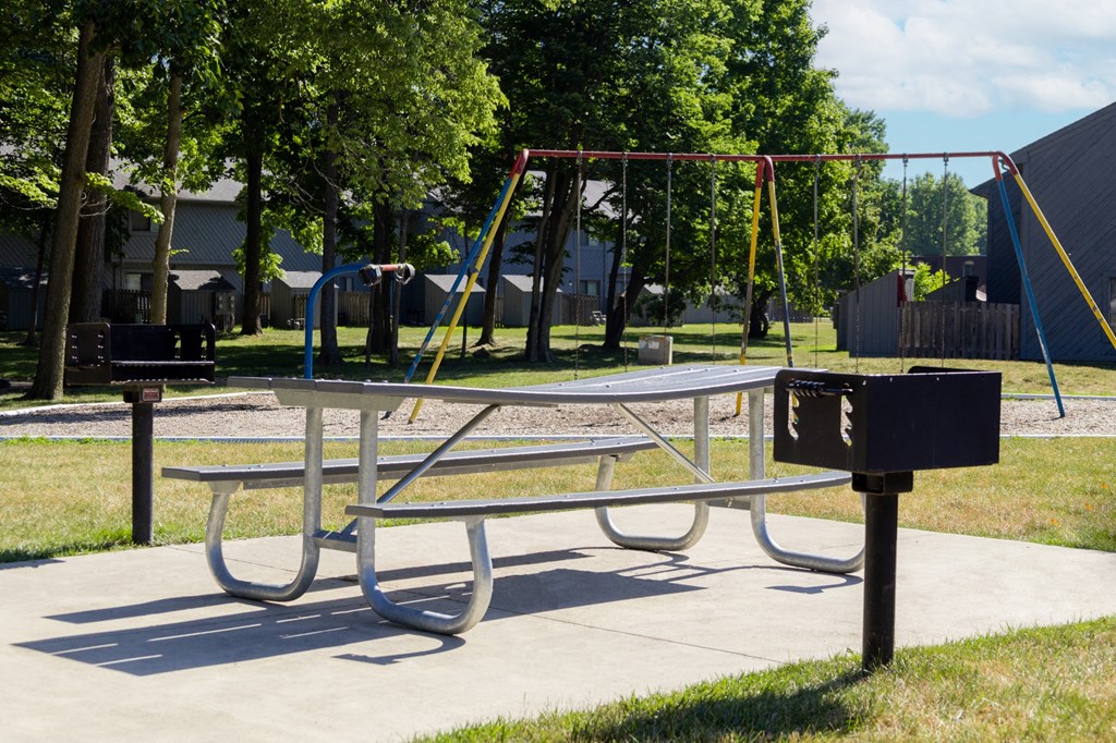 Playground with grilling stations at Woodlake Apartments