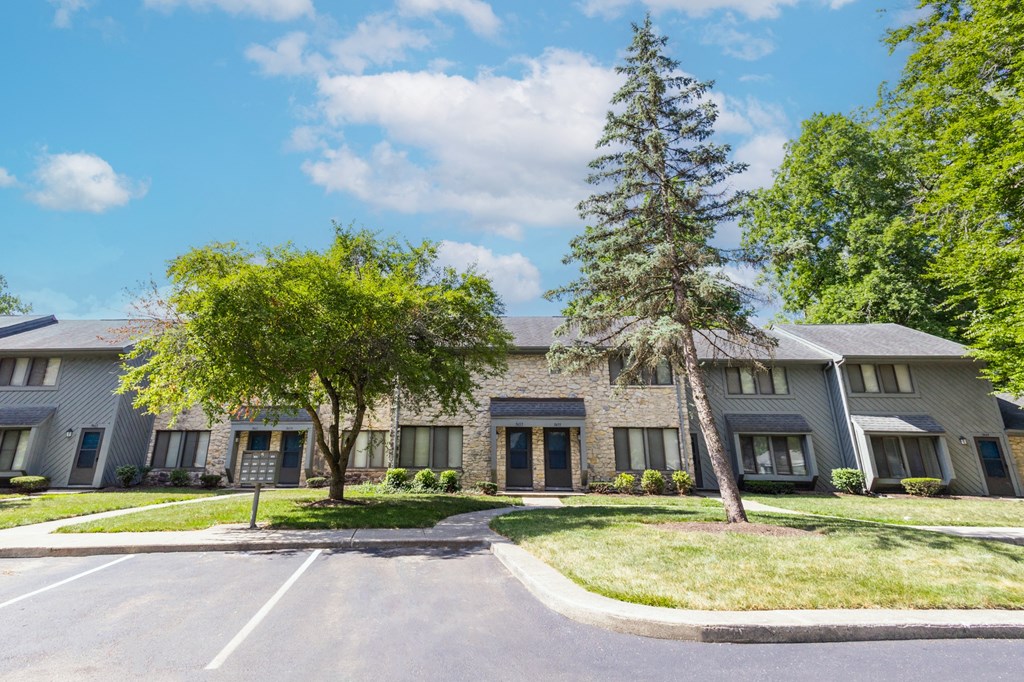 Exterior building with front row parking at Woodlake Apartments