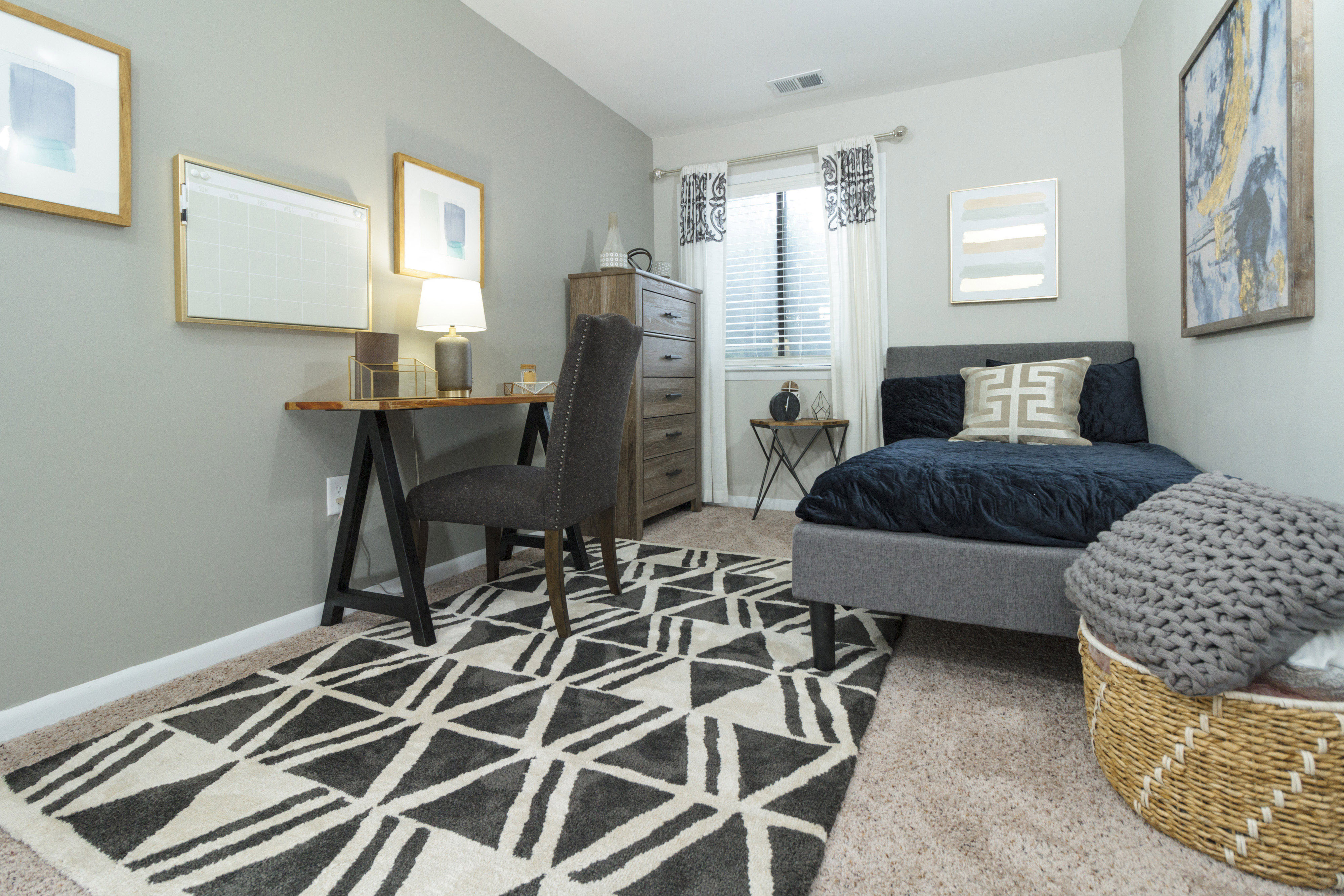 Bright and spacious bedroom with neutral wall colors at Woods of Fairfax