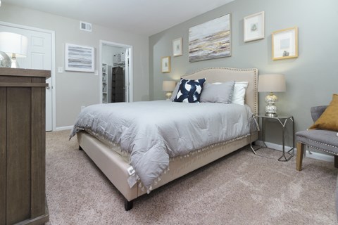 Spacious master bedroom, featuring furnishings at The Woods of Fairfax Apartments, Lorton