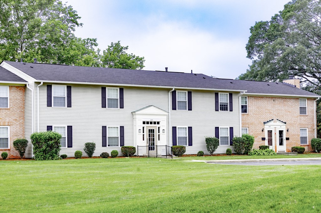 a white house with a yard in front of it