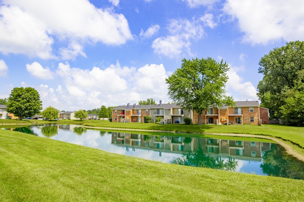 a large pond in front of a apartment building