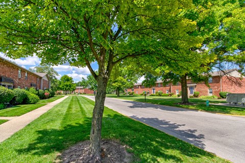 An exterior view of Bradford Lake Apartments with beautifully landscaped sidewalks