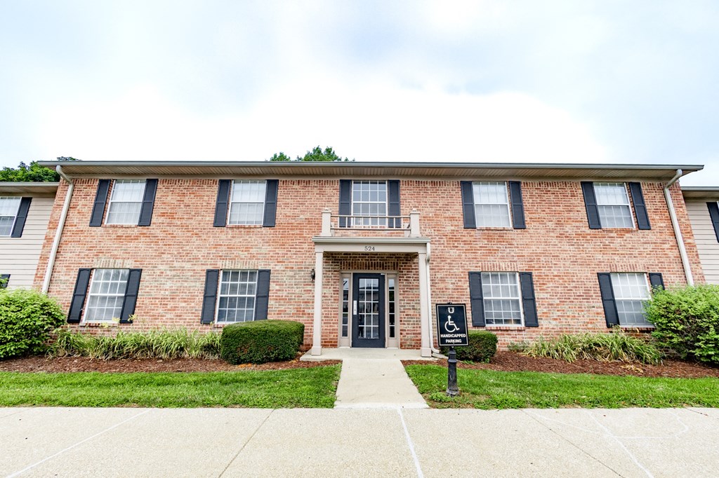 a brick building with a sidewalk in front of it