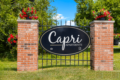 Monument sign for Capri Meadows Apartments, prominently displayed in front of the property with landscaped surroundings.
