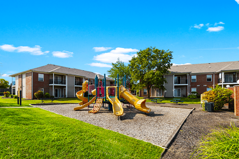 Playground at Brownsburg Pointe Apartments with colorful play structures and open play area.