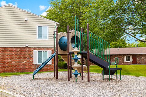Playground with a slide and playset at  Capri Meadows Apartments.