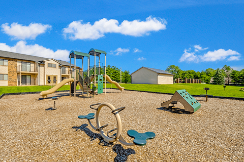 Playground at Thompson Village Apartments, featuring colorful equipment and  play area.