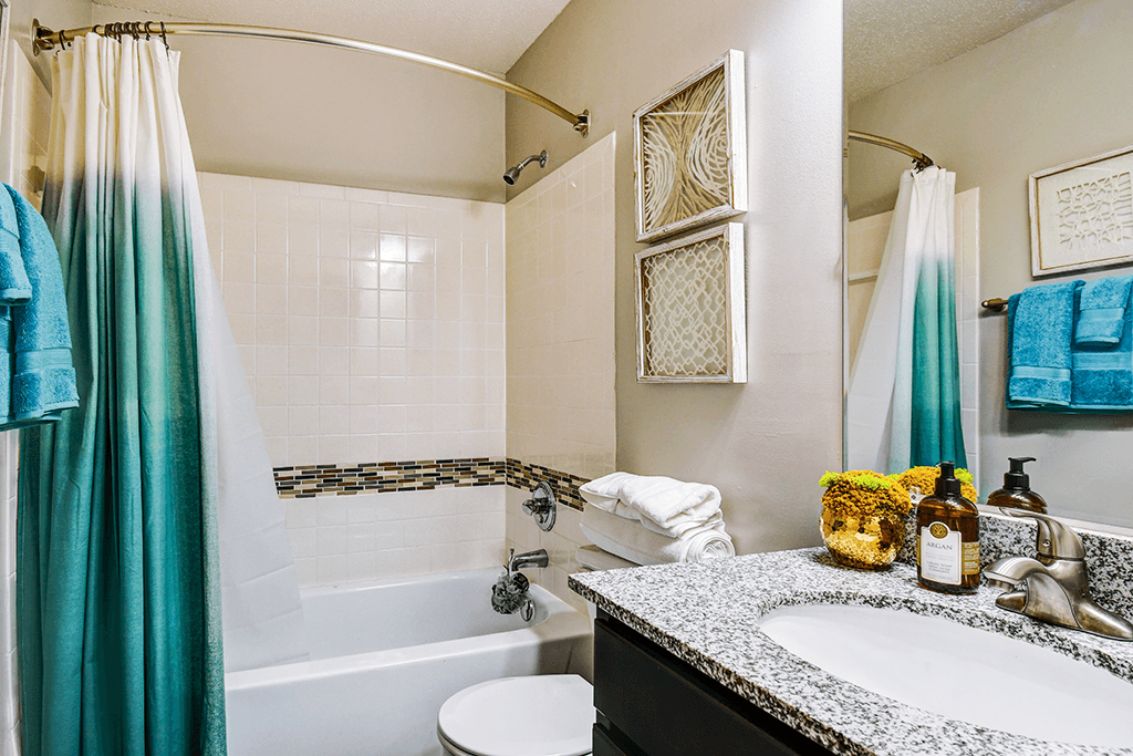 Bathroom in a 1-bed, 1-bath apartment at Ashton Brook, featuring a bathtub, toilet and vanity.