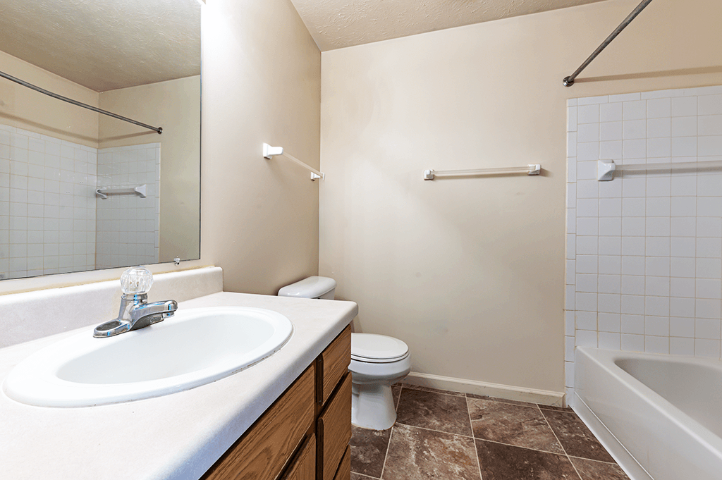 Bathroom with a sink, toilet, and bathtub in a two-bedroom, two-bath apartment at North Lake Apartments.