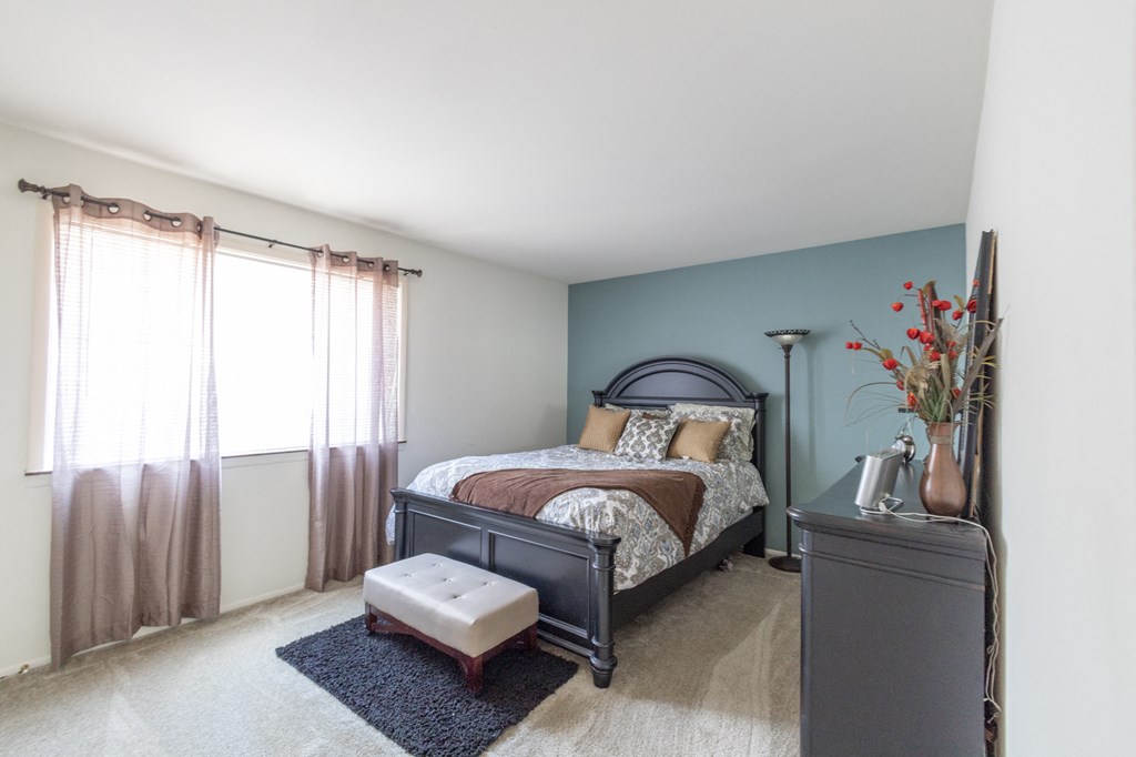 Spacious bedroom with a window in the 1 bedroom apartment at Woodbridge Apartments