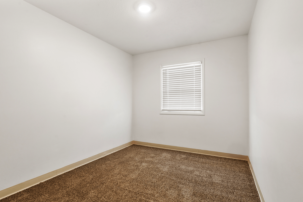 Bedroom in a 2-bedroom, 1-bathroom townhome at Country View Apartments.