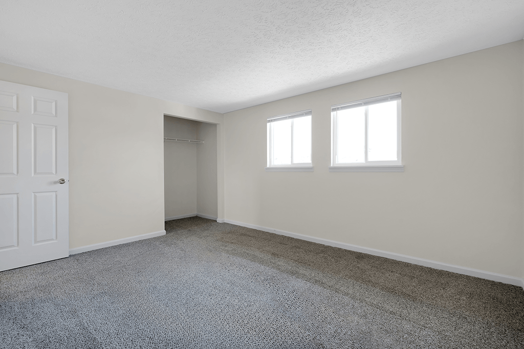 Bedroom in a 2-bed, 1-and-a-half-bath townhome at Colonial Village Apartments.