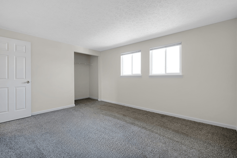 Bedroom in a 2-bed, 1-and-a-half-bath townhome at Colonial Village Apartments.