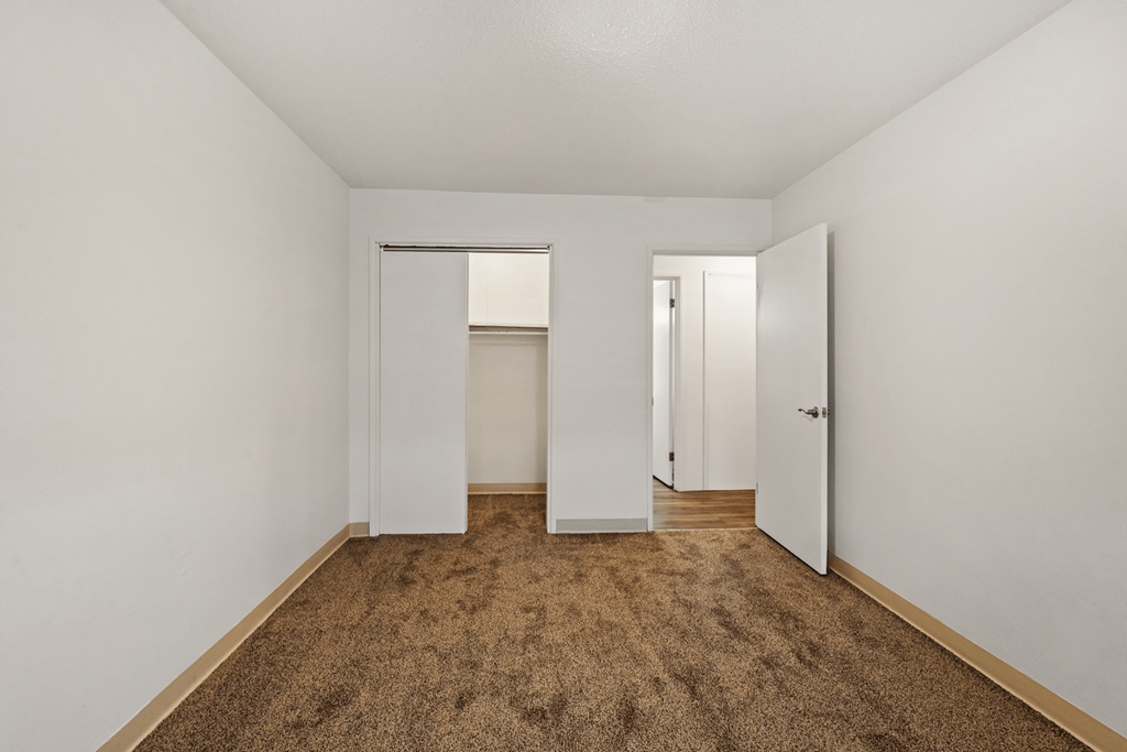 Bedroom with a closet in a 2-bedroom, 1-bathroom townhome with carpeted floor at Country View. Apartments.