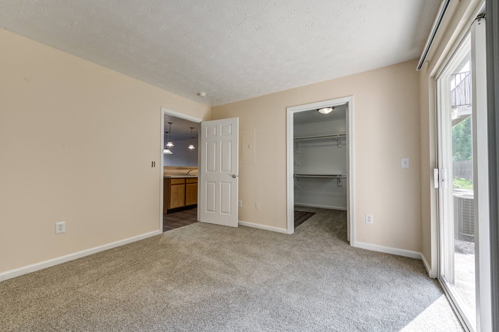 Bedroom with a closet and glass sliding door to the patio at Brownsburg Pointe.