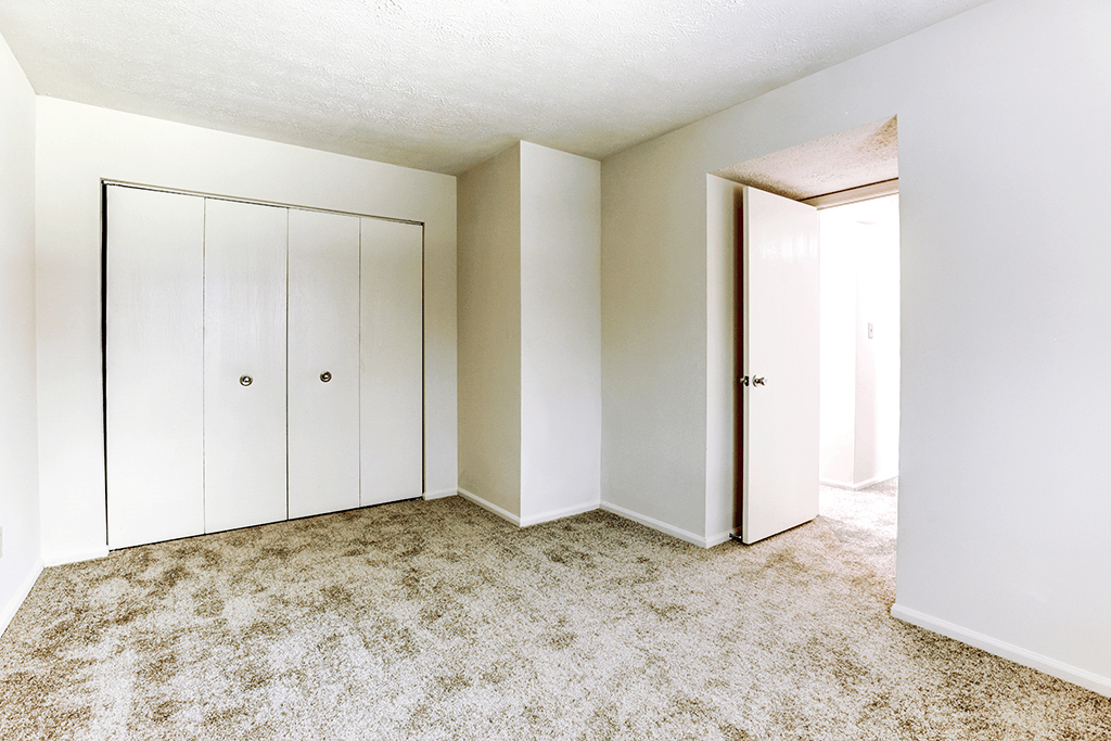 Bedroom with a closet at Thompson Village Apartments, Indiana