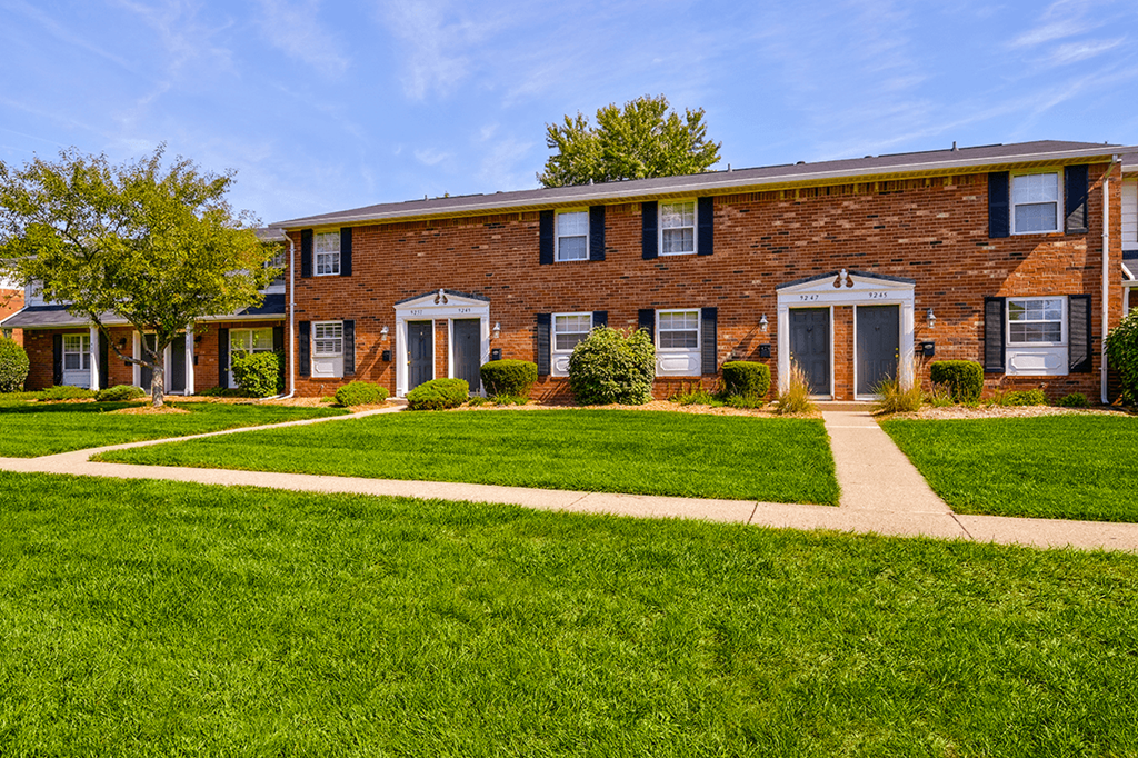 Exterior view of Ashton Brook Apartments, showcasing the building's architecture and surrounding landscaping.