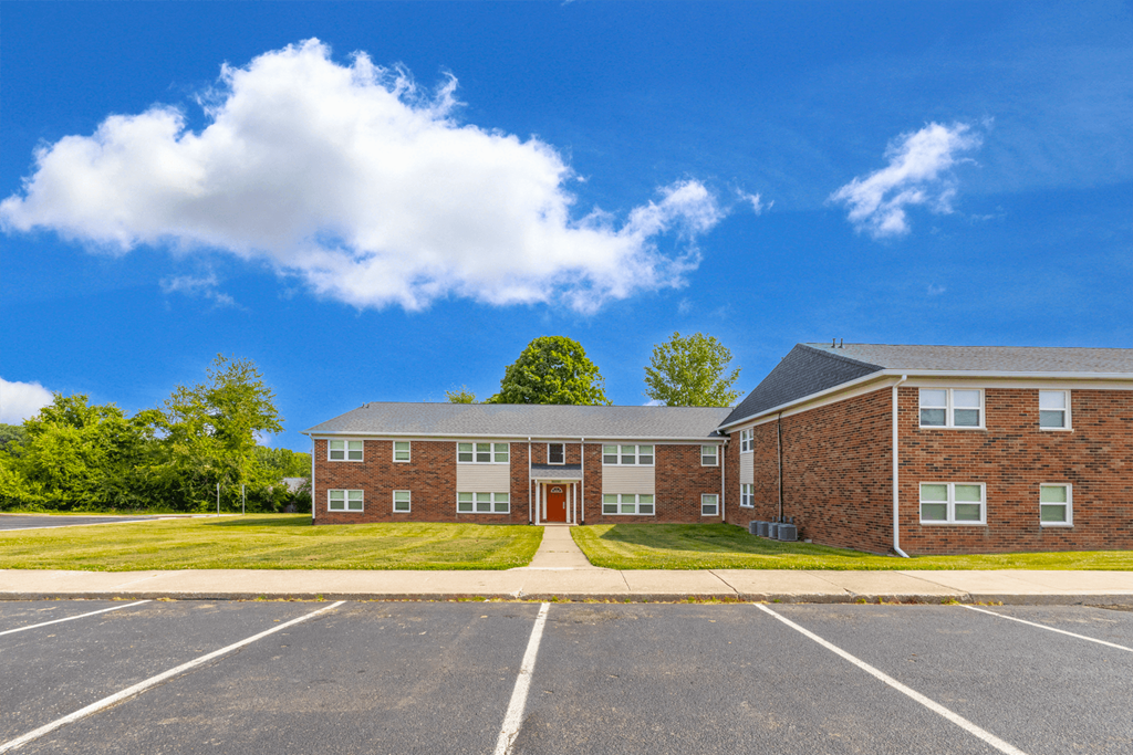 Exterior view of Country View Apartments, showcasing a charming building design surrounded by lush greenery.