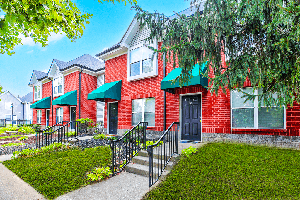 Exterior view of the building at Hampton Place Apartments, showcasing architecture and well-maintained landscaping.