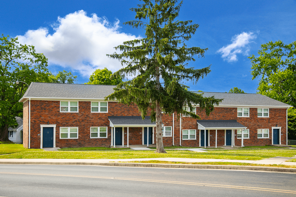 Exterior view of Country View Apartments, showcasing a charming building design surrounded by landscaped greenery.
