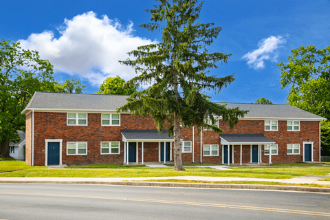 Exterior view of Country View Apartments, showcasing a charming building design surrounded by landscaped greenery.