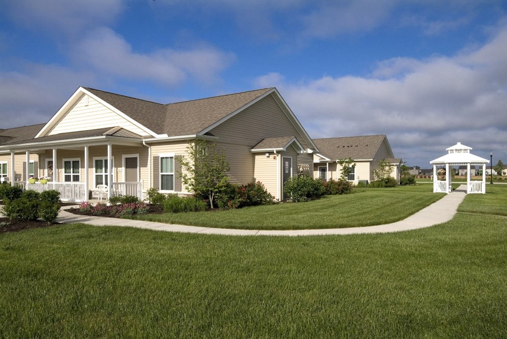 Side view of Meredith Meadows Apartments exterior with surrounding greenery.