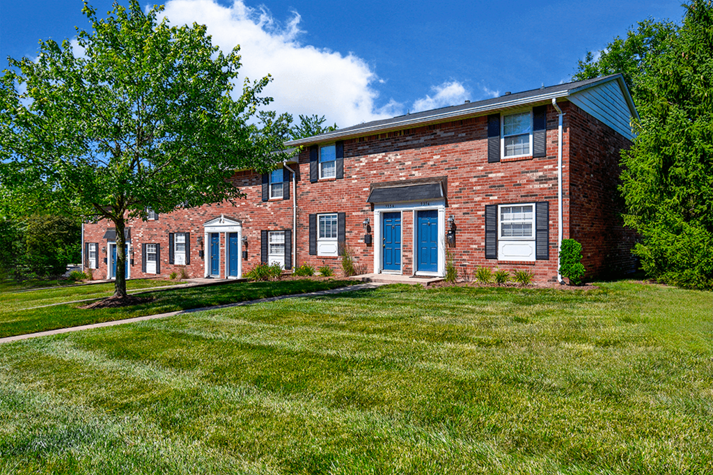 Exterior view of Ashton Brook Apartments, showcasing the building's architecture and surrounding landscaping.